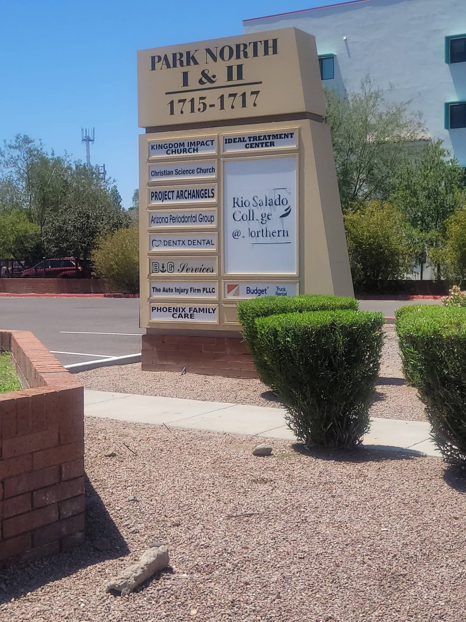 Close view of the building directory sign listing Phoenix Family Care among the tenants